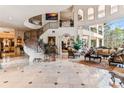 Elegant living room featuring a sweeping staircase and ornate details at 9452 Swaying Branch Rd, Sarasota, FL 34241