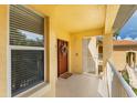 Condo entryway with a wreath and white railings at 7187 Boca Grove Pl # 202, Lakewood Ranch, FL 34202