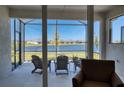 Relaxing screened lanai with comfortable seating and a serene lake view at 251 Okeeffe Cir, Bradenton, FL 34212