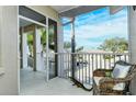 Spacious screened patio with a wicker chair and a decorative gator statue at 111 Woodbridge Dr # 202, Venice, FL 34293