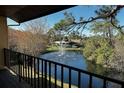 Peaceful pond view from private balcony, featuring a water fountain at 947 Sunridge Way # A-3, Sarasota, FL 34234