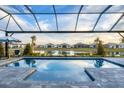 Resort-style pool with covered lanai overlooking lake at 8983 Baroque Ter, Sarasota, FL 34240