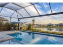 Relaxing pool and patio area with water view at 8983 Baroque Ter, Sarasota, FL 34240