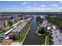 Aerial view of waterfront community with multiple buildings, boat slips, and lush landscaping at 1215 S Portofino Dr # 404, Sarasota, FL 34242