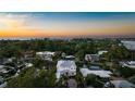 Stunning sunset aerial view of waterfront home and neighborhood at 1243 Starboard Ln, Sarasota, FL 34242