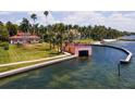 Waterfront home with boat house and lush landscaping at 4511 Bay Shore Rd, Sarasota, FL 34234