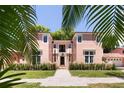 Front view of charming pink house with manicured hedges at 4511 Bay Shore Rd, Sarasota, FL 34234