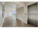 Clean condo hallway with elevator access and exit signage at 7201 29Th Avenue W Dr # 306, Bradenton, FL 34209