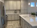 Modern kitchen with an island, stainless steel appliances, and light-colored cabinets at 1045 Crosswind Ave, Sarasota, FL 34240