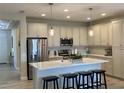 Modern kitchen with an island, stainless steel appliances, and light-colored cabinets at 1045 Crosswind Ave, Sarasota, FL 34240