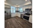 Modern kitchen featuring stainless steel appliances and white cabinets at 150 Rotonda Cir, Rotonda West, FL 33947