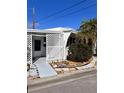 Charming home exterior with white lattice feature and low maintenance landscaping at 68 4Th Ave, Venice, FL 34285