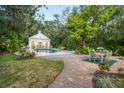 Inviting pool area with patio furniture and lush landscaping at 75 Osprey Point Dr, Osprey, FL 34229