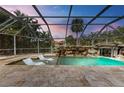 Relaxing pool and spa area with waterfall feature and screened enclosure at 2501 Broad St, Nokomis, FL 34275