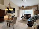 Spacious living room with a dining area and sliding glass doors at 7225 Cedar Hollow Cir # 20-201, Bradenton, FL 34203