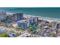 Aerial view of beachfront condo building with ocean and street views at 1102 Benjamin Franklin Dr # 409, Sarasota, FL 34236