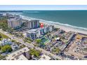 Aerial view of beachfront condo building with ocean and tennis court views at 1102 Benjamin Franklin Dr # 409, Sarasota, FL 34236