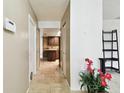 Hallway with tile flooring, leading to kitchen and closets at 117 Hillcrest Dr, Bradenton, FL 34209