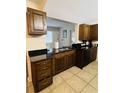 Kitchen features dark wood cabinets and granite countertops at 2549 Arapaho St, Sarasota, FL 34231