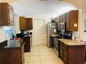 Galley style kitchen with granite countertops and stainless steel appliances at 2549 Arapaho St, Sarasota, FL 34231