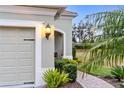 Well-lit walkway leading to a garage with lush landscaping at 5450 Fairfield Blvd, Bradenton, FL 34203