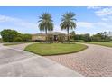 Stunning curb appeal with palm trees and brick driveway at 8480 Big Buck Ln, Sarasota, FL 34240