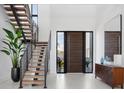 Bright and spacious entryway with modern staircase and large front door at 1212 Center Pl, Sarasota, FL 34236