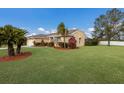 Exterior view of a single-story house with lush landscaping at 4135 Dover E Dr, Bradenton, FL 34203