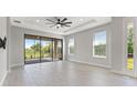 Bright living area with tile floors, large windows, and sliding glass doors at 3121 Tolmino Ct, Bradenton, FL 34211