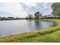 Peaceful lakefront view with homes and lush greenery at 455 Park Trace Blvd, Osprey, FL 34229