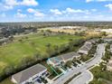 Aerial view of a neighborhood featuring lush greenery, a sprawling sports field, and neatly arranged residential properties at 14847 Skip Jack Loop, Lakewood Ranch, FL 34202