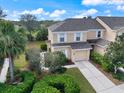 Beautiful two-story home with a manicured lawn, mature trees, and a welcoming two-car garage at 14847 Skip Jack Loop, Lakewood Ranch, FL 34202