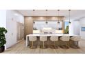 Modern kitchen with white cabinets, marble countertops, and island seating at 109 N Warbler Ln, Sarasota, FL 34236