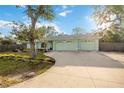 Light green home featuring an attached two car garage and large driveway at 611 Mobile Rd, Venice, FL 34293