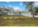 Charming home showcasing manicured front lawn and light green exterior at 611 Mobile Rd, Venice, FL 34293