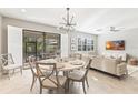 Elegant dining room with a round table and chairs, near the kitchen at 655 Resolute St, Nokomis, FL 34275
