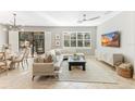Spacious living room featuring a comfortable sectional sofa and large TV at 655 Resolute St, Nokomis, FL 34275