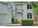 Welcoming front entrance features elegant double doors, arched windows, and charming landscaping at 228 36Th Ne St, Bradenton, FL 34208