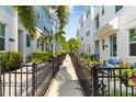 Townhouse community walkway with lush landscaping at 2400 Ezzell Ct, Sarasota, FL 34237