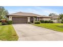 Single story home with brown garage door and large front yard at 1478 Navigator Rd, Punta Gorda, FL 33983