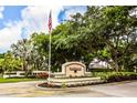 Southwood community entrance with lush landscaping and flag at 4872 Limetree Ln, Venice, FL 34293