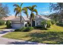 Charming single-story home with manicured lawn, mature landscaping, and a two-car garage at 12240 Thornhill Ct, Lakewood Ranch, FL 34202