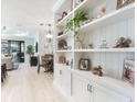 White built-in shelving with coastal decor, view into dining area at 12640 Coastal Breeze Way, Bradenton, FL 34211