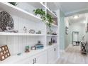 White built-in shelving with coastal decor in a light hallway at 12640 Coastal Breeze Way, Bradenton, FL 34211