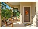 Inviting front porch with rocking chairs and autumnal decor at 12640 Coastal Breeze Way, Bradenton, FL 34211