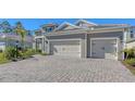 Brick paver driveway leading to a three-car garage at 21205 Holmes Cir, Venice, FL 34293