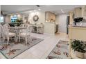 Bright dining area with glass table and white chairs, features coastal decor at 4119 61St Avenue W Ter # 105, Bradenton, FL 34210