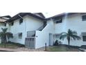 Front view of a light-colored building with stairs and landscaping at 4234 Gulf Of Mexico Dr # Y2, Longboat Key, FL 34228