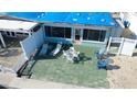 Quaint patio with seating area, adjacent to waterfront home at 23 Seaside Ct, Holmes Beach, FL 34217