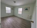 Bright bedroom with light walls and wood-look floors at 5026 Calle Minorga, Sarasota, FL 34242